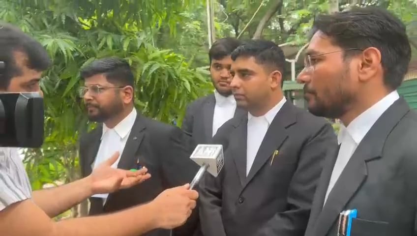 Advocate Sameer Malik with legal team during a press interaction, showcasing dedication and professionalism.